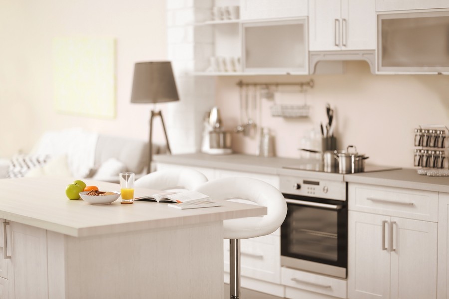 A brightly lit, all-white kitchen. 